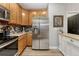 Modern kitchen featuring stainless steel refrigerator, stainless steel appliances, and light wood cabinets at 7412 S Mobile St, Aurora, CO 80016