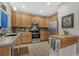 Well-lit kitchen showcases stainless steel appliances, modern cabinetry, and backsplash at 7412 S Mobile St, Aurora, CO 80016
