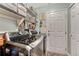 Functional laundry room with modern washer/dryer units and ample storage shelving at 7412 S Mobile St, Aurora, CO 80016