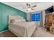 Cozy main bedroom features a ceiling fan, window, and plush bedding at 7412 S Mobile St, Aurora, CO 80016
