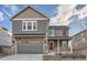 Two-story house with gray siding, stone accents, and a two-car garage at 20040 E 61St Dr, Aurora, CO 80019