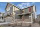 Two-story house with gray siding, stone accents, and a two-car garage at 20040 E 61St Dr, Aurora, CO 80019