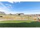 Lush backyard featuring artificial turf, framed garden beds and distant neighborhood views at 4757 Augustine Ct, Castle Rock, CO 80108
