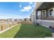 A well-maintained backyard with lush green artificial turf and a charming wood fence at 4757 Augustine Ct, Castle Rock, CO 80108