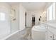 Bright bathroom featuring double vanities, soaking tub, and a separate glass-enclosed shower at 4757 Augustine Ct, Castle Rock, CO 80108