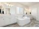 Spacious primary bathroom with dual sinks, a soaking tub, and white cabinetry at 4757 Augustine Ct, Castle Rock, CO 80108