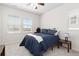 Comfortable bedroom with two windows and neutral carpet, featuring a queen bed and lamp at 4757 Augustine Ct, Castle Rock, CO 80108
