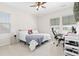 Sunlit bedroom with neutral carpet features two windows and a ceiling fan at 4757 Augustine Ct, Castle Rock, CO 80108