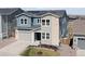 Inviting two-story home featuring a well-manicured lawn, two car garage, and solar panels at 4757 Augustine Ct, Castle Rock, CO 80108