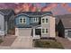 Beautiful two-story home featuring stone accents, a two-car garage, and solar panels against a colorful sky at 4757 Augustine Ct, Castle Rock, CO 80108