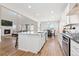 Open-concept kitchen with island seating, granite countertops, stainless steel appliances, dining area, and fireplace at 4757 Augustine Ct, Castle Rock, CO 80108