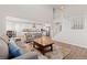 Open-concept living space with stairs, seamlessly connecting to the kitchen with a breakfast bar and dining area at 4757 Augustine Ct, Castle Rock, CO 80108