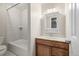 Clean bathroom with vanity and tiled shower/tub at 376 Upham St, Lakewood, CO 80226