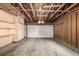 Spacious garage featuring a clean concrete floor, exposed wooden beams, and ample room for parking and storage at 376 Upham St, Lakewood, CO 80226