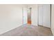 Bedroom featuring new carpeting and a door to the hallway at 1050 S Lewiston Way, Aurora, CO 80017