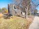 Property view featuring a well-kept lawn, mature trees, and a classic two-story home at 1050 S Lewiston Way, Aurora, CO 80017