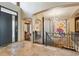 Elegant entryway with modern staircase and artistic wall decor at 9081 E Wesley Dr, Denver, CO 80231