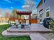 Spacious backyard patio with fire pit, pergola, and seating area at 16507 Oakmoor Pl, Parker, CO 80134