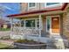 Inviting front porch with wooden railing and a charming entrance at 16507 Oakmoor Pl, Parker, CO 80134