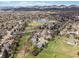 Picturesque community featuring a serene lake and stunning mountain views in the distance at 10624 W Berry Pl, Littleton, CO 80127