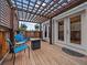 Cozy backyard deck with a pergola, comfortable seating and direct access to the home's interior at 10624 W Berry Pl, Littleton, CO 80127