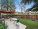 Landscaped backyard featuring a patio with outdoor dining and access to a second-story deck at 10624 W Berry Pl, Littleton, CO 80127