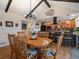 Dining area open to kitchen featuring hardwood floors, vaulted ceilings, and plenty of light at 10624 W Berry Pl, Littleton, CO 80127