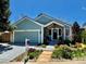 Charming single-Gathering home featuring a well-manicured front yard with colorful flowerbeds and a cozy, covered entryway at 10624 W Berry Pl, Littleton, CO 80127