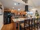 Modern kitchen with granite countertops, stainless steel appliances, and breakfast bar seating at 10624 W Berry Pl, Littleton, CO 80127