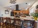 Modern kitchen with granite countertops, stainless steel appliances, island seating and stone backsplash at 10624 W Berry Pl, Littleton, CO 80127