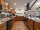 Well-lit kitchen featuring wooden cabinets, stainless steel appliances, and stylish countertops and backsplash at 10624 W Berry Pl, Littleton, CO 80127