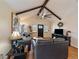 Bright living room with vaulted ceilings, hardwood floors, and comfortable leather sofas at 10624 W Berry Pl, Littleton, CO 80127