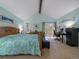 Bright primary bedroom with vaulted ceiling and direct access to the private deck at 10624 W Berry Pl, Littleton, CO 80127