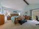 Bright bedroom with vaulted ceiling, wooden accents, and access to a private balcony at 10624 W Berry Pl, Littleton, CO 80127