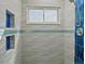 Modern shower with decorative blue tile accents and built-in storage niche at 10624 W Berry Pl, Littleton, CO 80127