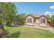 Spacious backyard featuring a well-manicured lawn, a charming patio area, and mature trees at 2864 S Jebel Way, Aurora, CO 80013