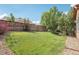 Expansive backyard with lush green lawn, mature trees, and a stone-lined garden bed at 2864 S Jebel Way, Aurora, CO 80013
