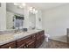 Elegant bathroom with a dual sink vanity, granite countertops, and modern fixtures at 2864 S Jebel Way, Aurora, CO 80013