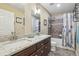 Bathroom featuring granite counter tops, tile flooring, and a shower-tub combo at 2864 S Jebel Way, Aurora, CO 80013