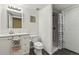 Well-lit bathroom with a shower, toilet, and single sink vanity, designed for functionality and convenience at 2864 S Jebel Way, Aurora, CO 80013