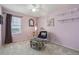Charming bedroom featuring soft lavender walls, a ceiling fan, and a cozy sitting area at 2864 S Jebel Way, Aurora, CO 80013