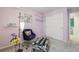Stylish bedroom featuring lavender walls, modern shelving, and cozy accent chair and ottoman at 2864 S Jebel Way, Aurora, CO 80013