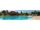 Large community pool surrounded by lounge chairs and umbrellas, perfect for summer relaxation at 2864 S Jebel Way, Aurora, CO 80013