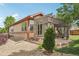 Beautiful home exterior with gravel yard, lush greenery, and a charming pergola-covered patio at 2864 S Jebel Way, Aurora, CO 80013