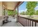 Inviting covered front porch with a cozy seating area, perfect for enjoying the neighborhood views at 2864 S Jebel Way, Aurora, CO 80013