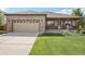 Charming brick home with a well-maintained lawn and covered front porch for relaxing and curb appeal at 2864 S Jebel Way, Aurora, CO 80013