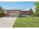 Charming brick home with a well-maintained lawn and covered front porch for relaxing and curb appeal at 2864 S Jebel Way, Aurora, CO 80013