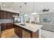 Open concept kitchen with stainless steel appliances, granite counters, dark cabinets, and seamless flow into living spaces at 2864 S Jebel Way, Aurora, CO 80013