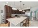 Stylish kitchen with stainless steel appliances, dark wood cabinets, granite countertops, and modern pendant lighting at 2864 S Jebel Way, Aurora, CO 80013