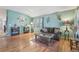 Bright living room with hardwood floors, a cozy sofa, and decorative accents creates a welcoming atmosphere at 2864 S Jebel Way, Aurora, CO 80013